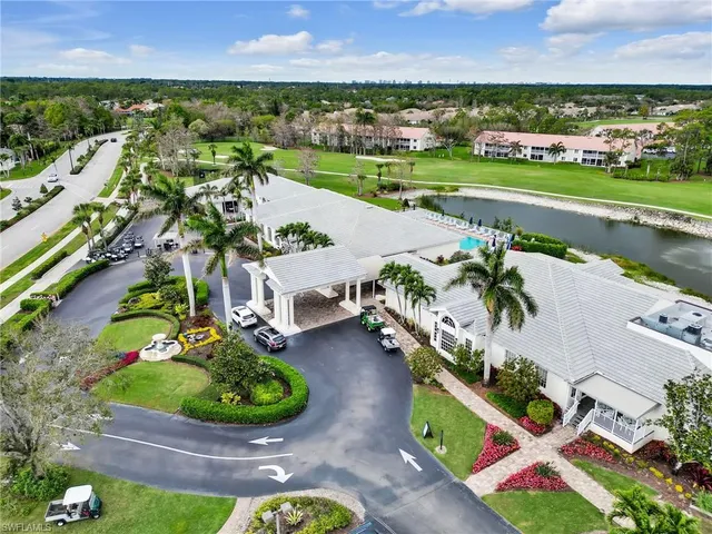 an aerial view of a house with a garden and lake view