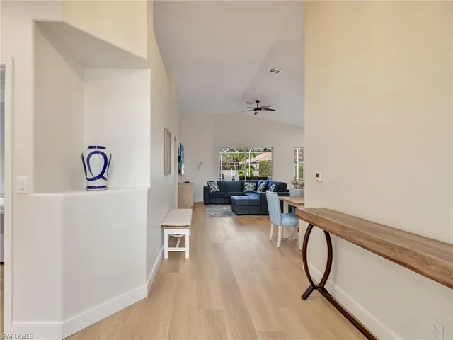 a view of a livingroom with furniture and hardwood floor