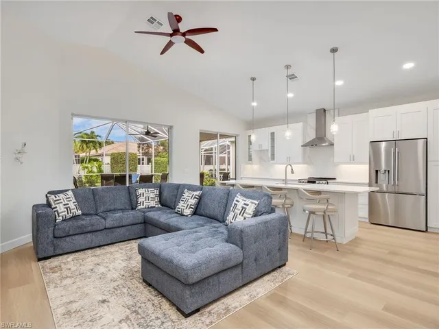 a living room with furniture and kitchen view