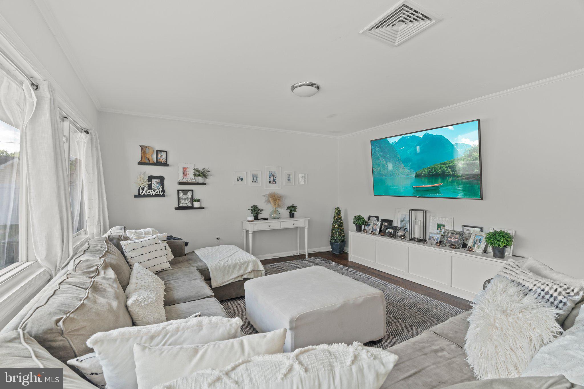 30 Roving Road Levittown, PA 19056 - Photo 11 of 40 a living room with furniture and a flat screen tv