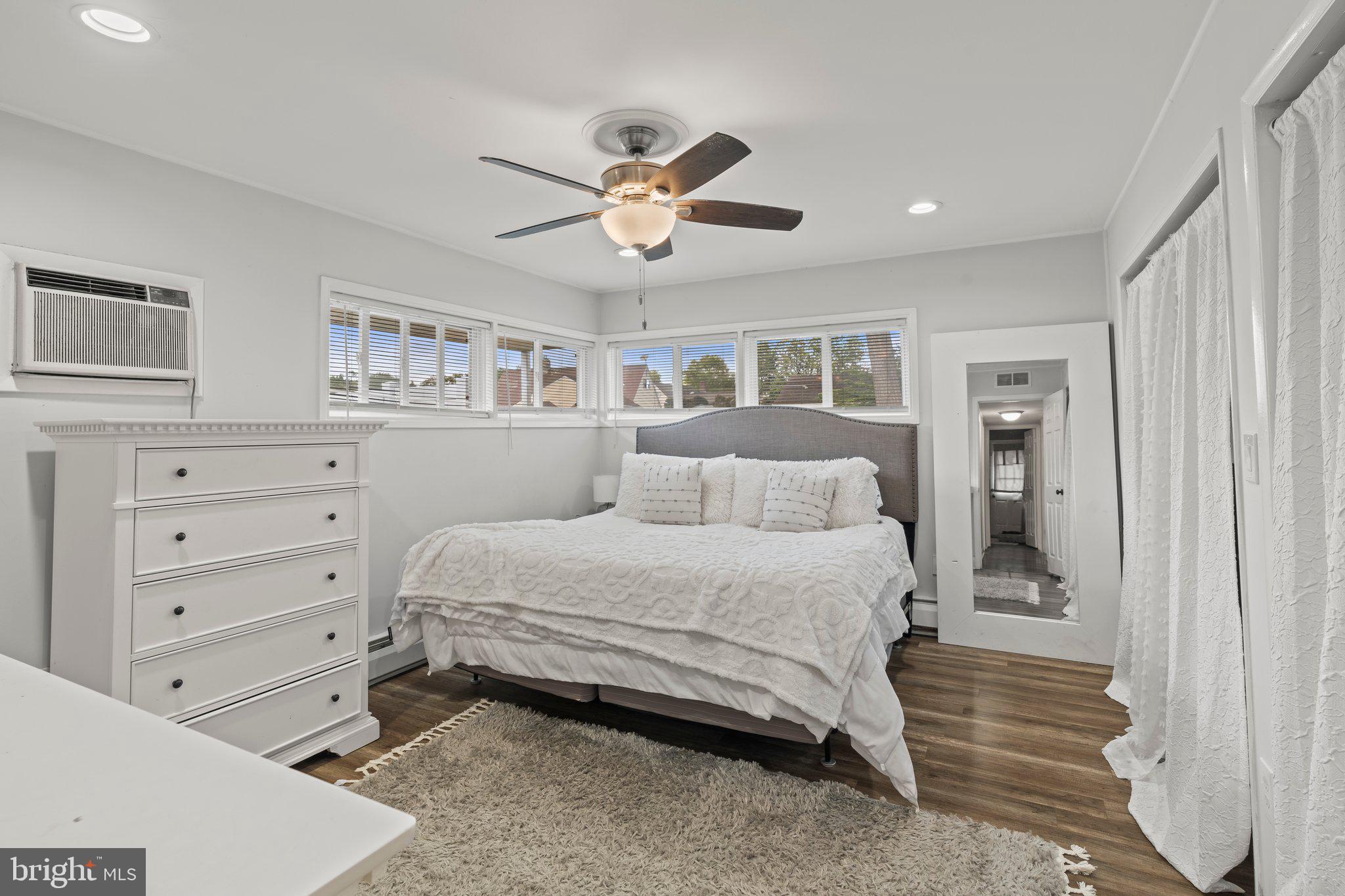 30 Roving Road Levittown, PA 19056 - Photo 20 of 40 a bedroom with a large bed and a chandelier