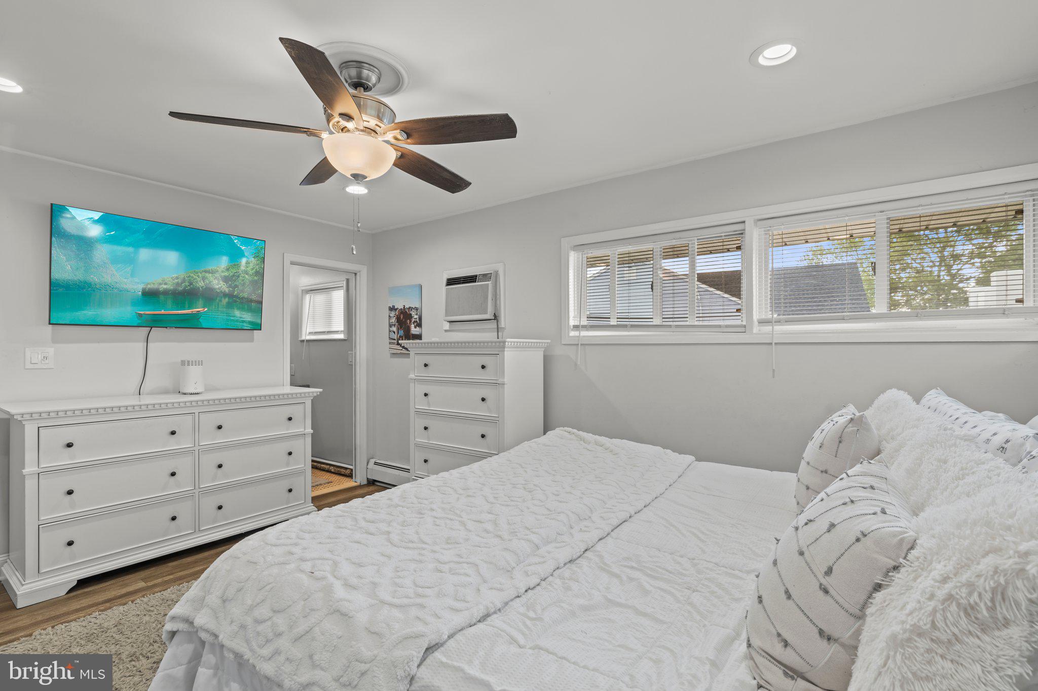 30 Roving Road Levittown, PA 19056 - Photo 21 of 40 a bedroom with a large bed and a flat tv screen on dresser