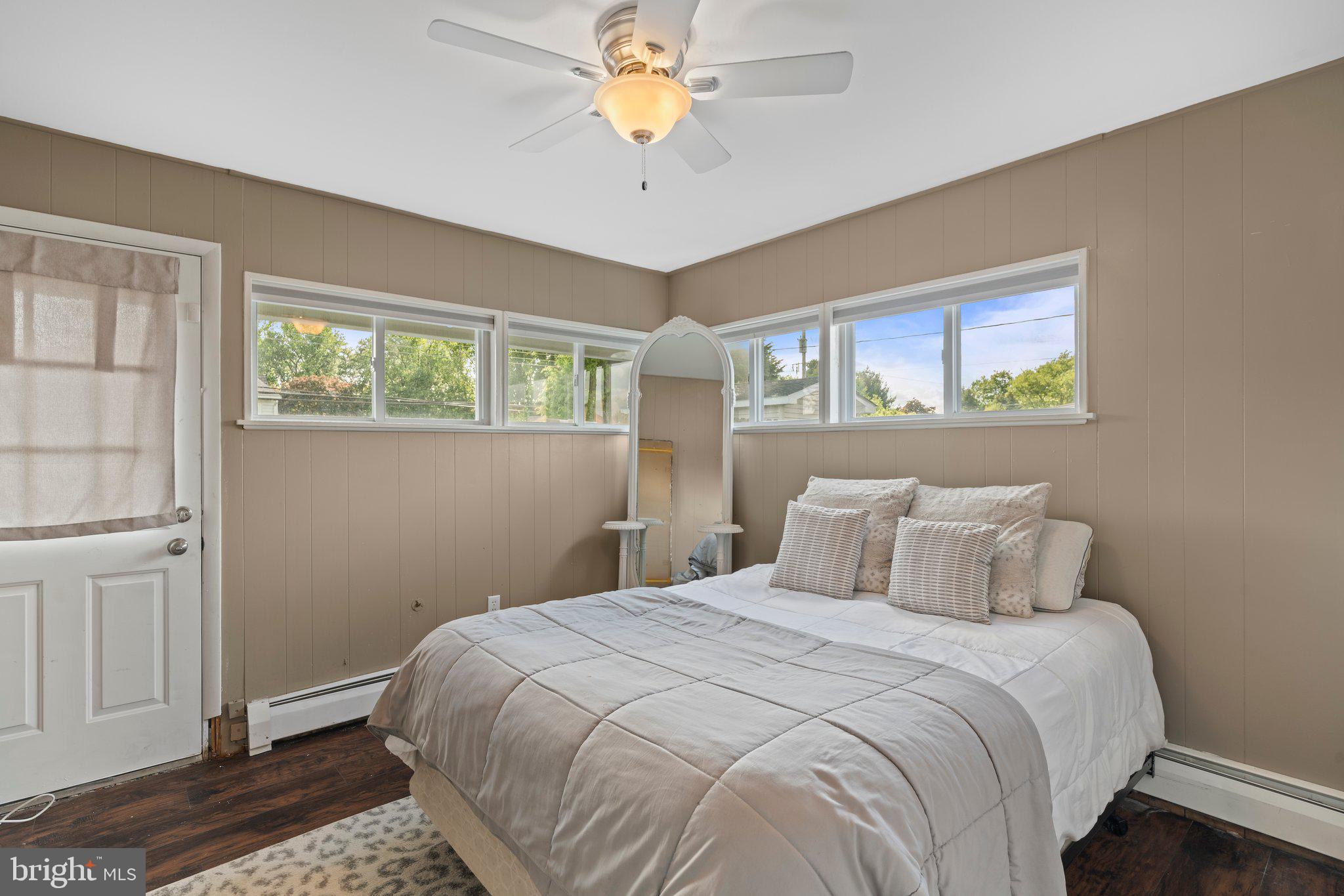 30 Roving Road Levittown, PA 19056 - Photo 23 of 40 a bedroom with a bed and a chandelier