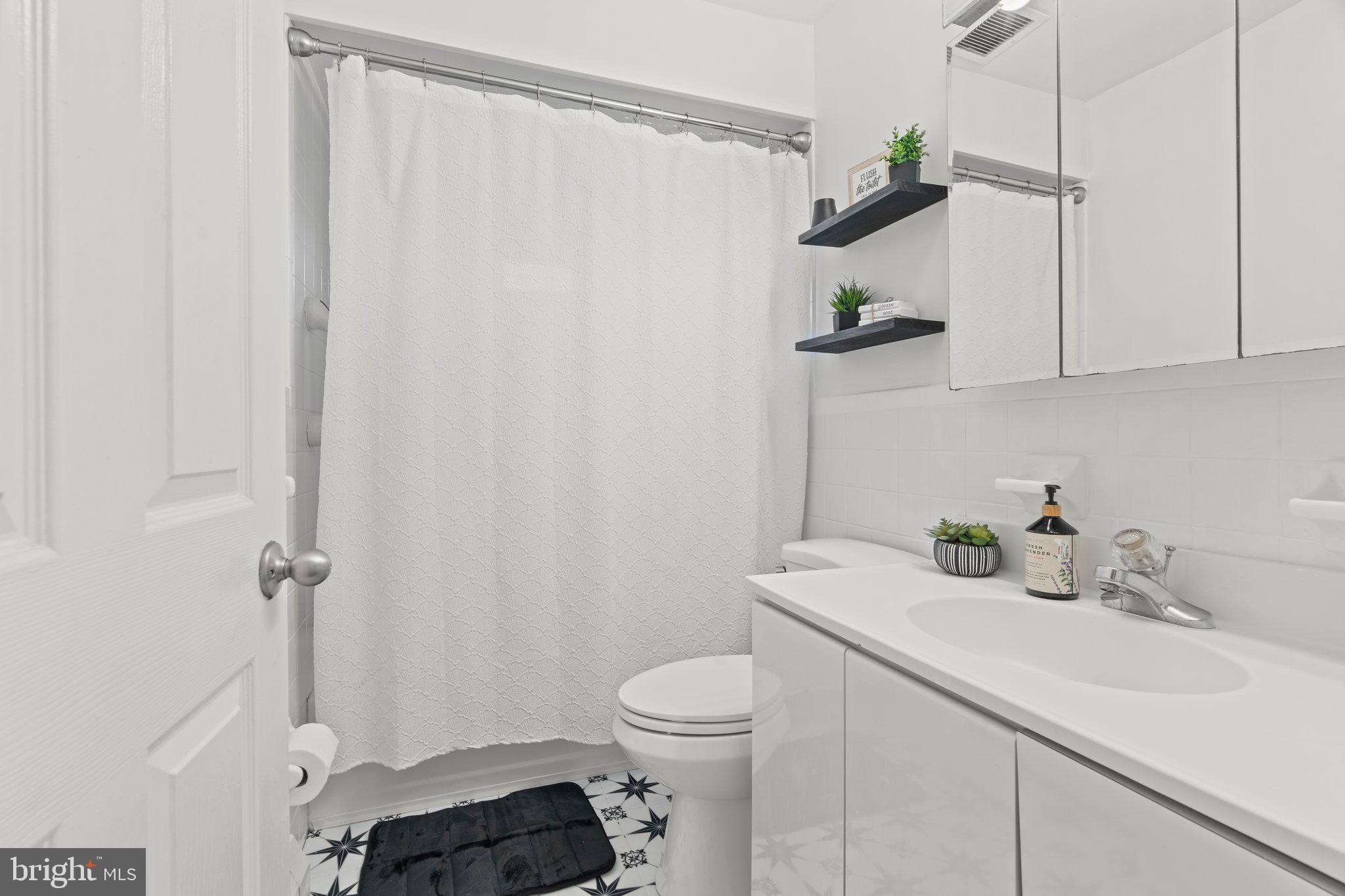 30 Roving Road Levittown, PA 19056 - Photo 25 of 40 a bathroom with a sink a toilet and shower