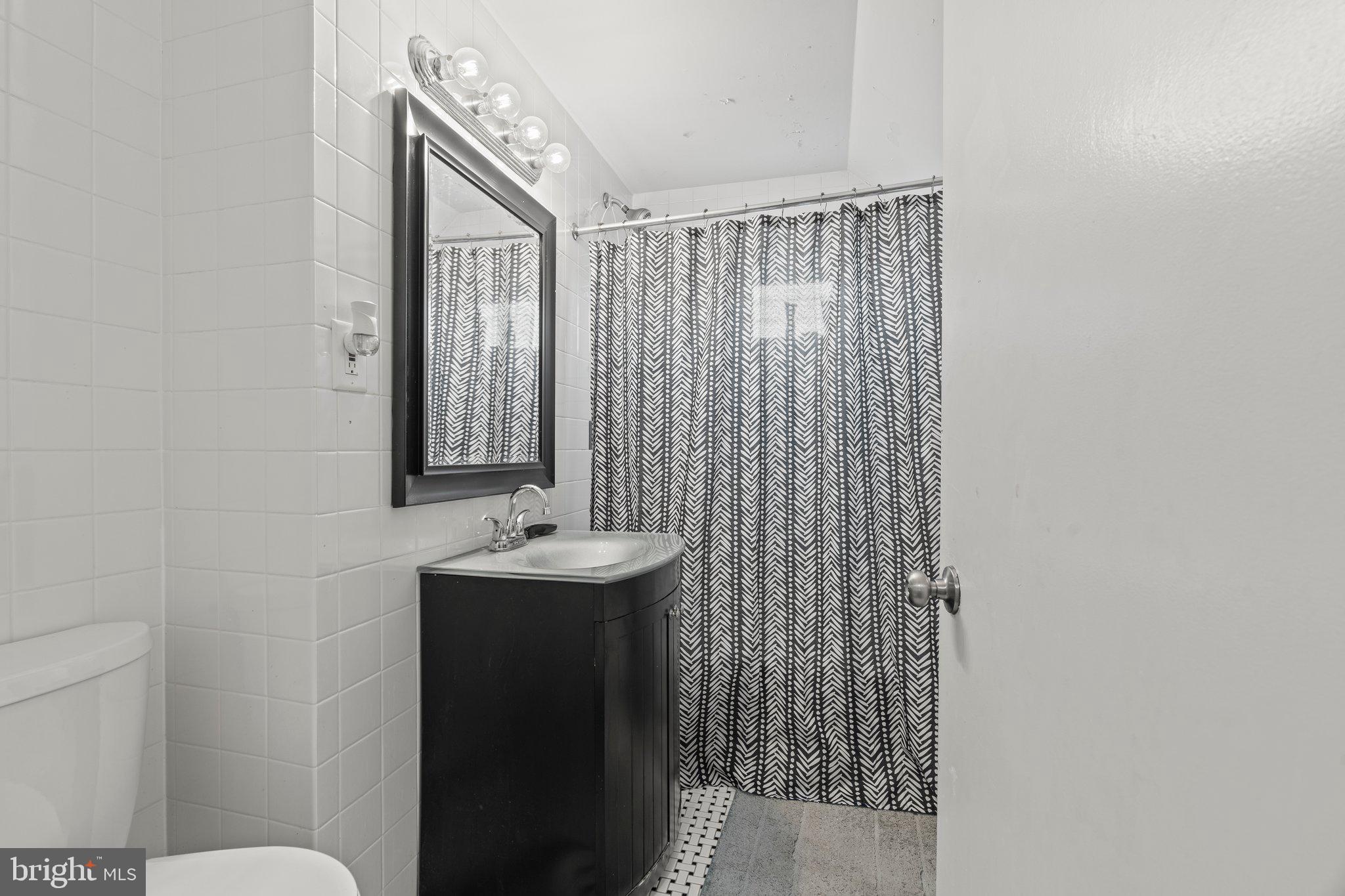 30 Roving Road Levittown, PA 19056 - Photo 29 of 40 a bathroom with a sink a toilet and mirror