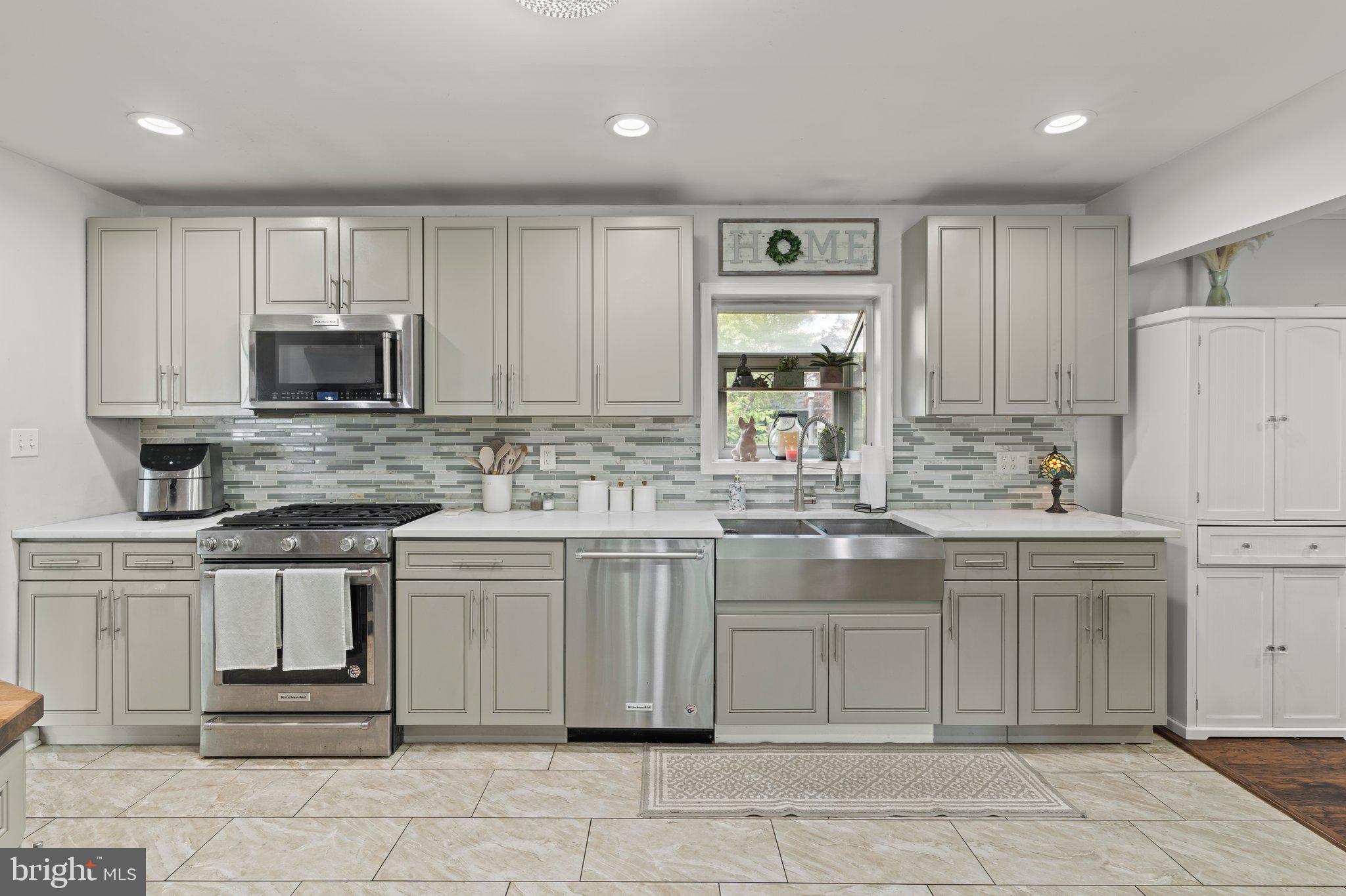 30 Roving Road Levittown, PA 19056 - Photo 5 of 40 a kitchen with cabinets and window