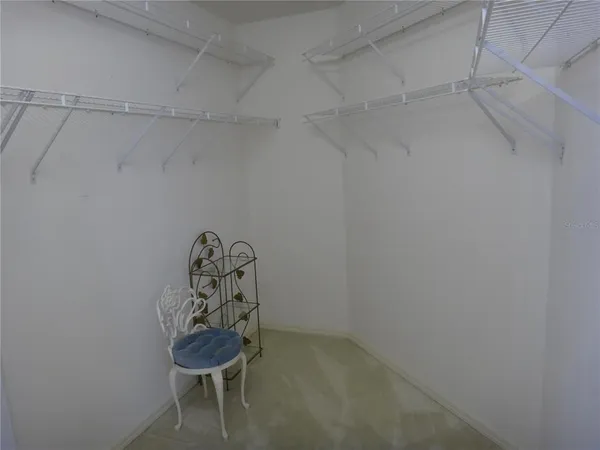 a room with water heater and wooden cabinets