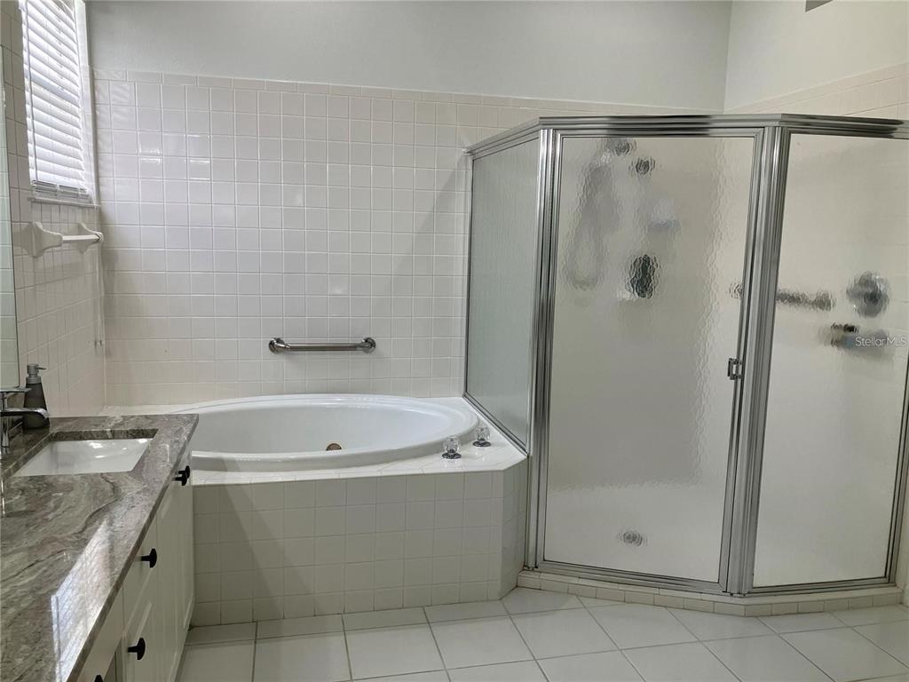 Undisclosed Address Sarasota, FL 34238 - Photo 15 of 26 a bathroom with a bathtub a shower and a sink