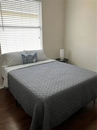 a bedroom with a bed and window