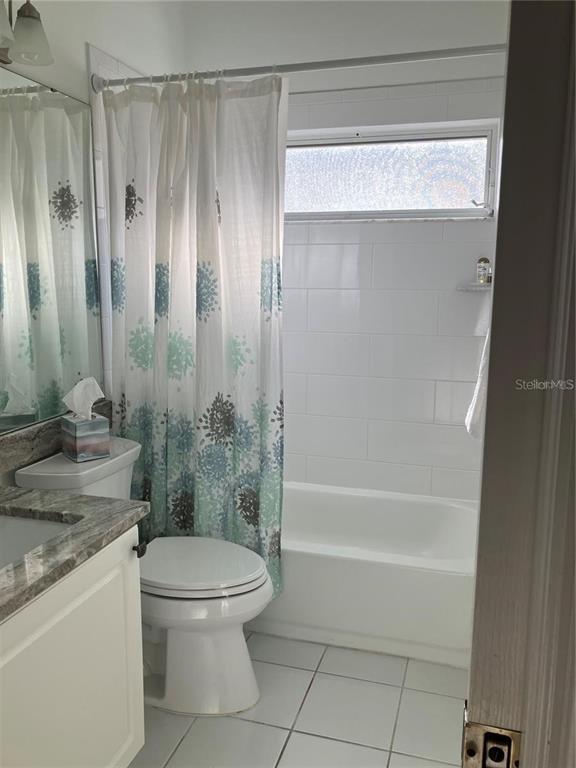 Undisclosed Address Sarasota, FL 34238 - Photo 19 of 26 a bathroom with a granite countertop bathtub shower sink vanity and toilet