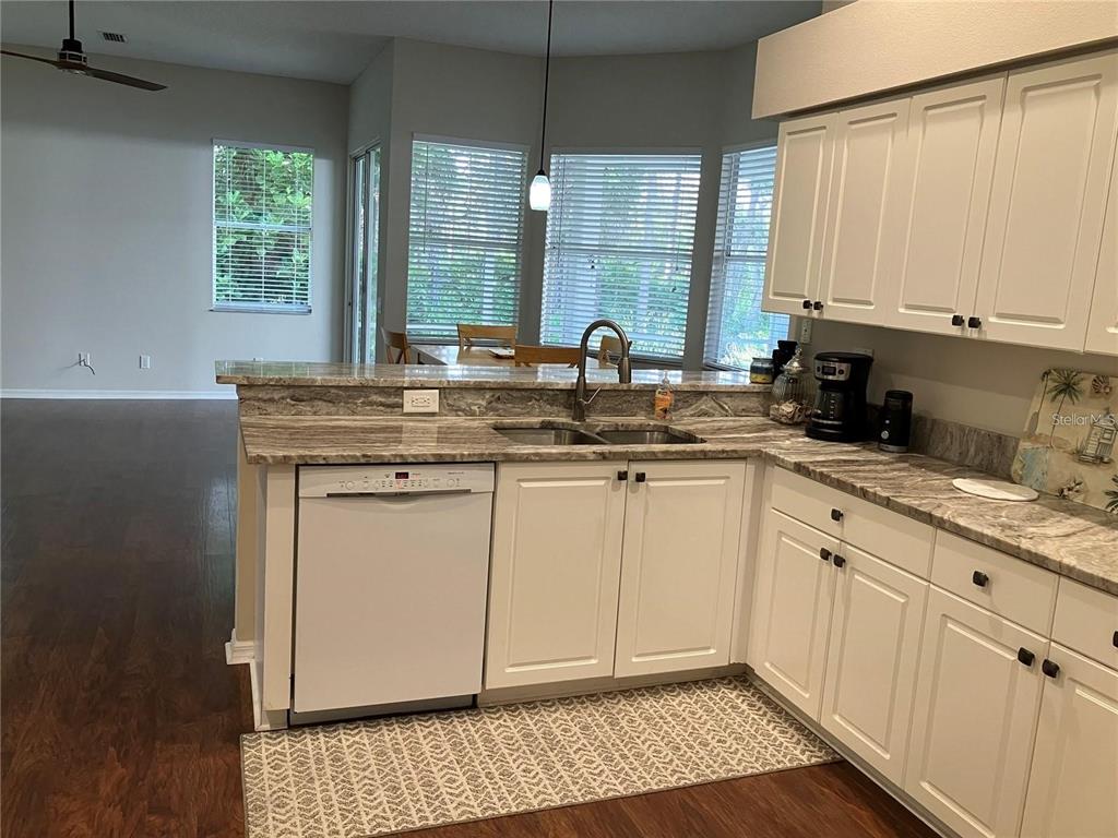 Undisclosed Address Sarasota, FL 34238 - Photo 7 of 26 a kitchen with stainless steel appliances granite countertop a sink stove and cabinets