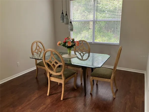 a dining room with furniture and window