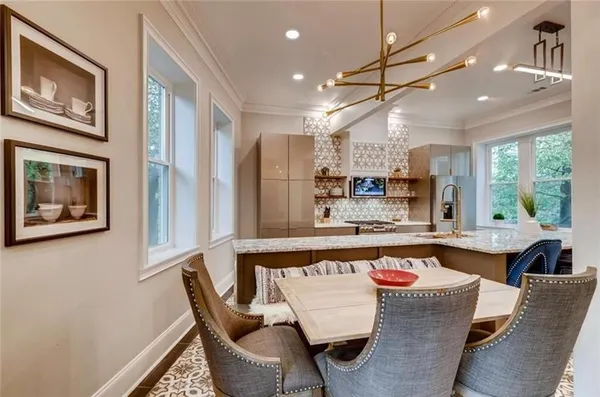 a large kitchen with a table and chairs