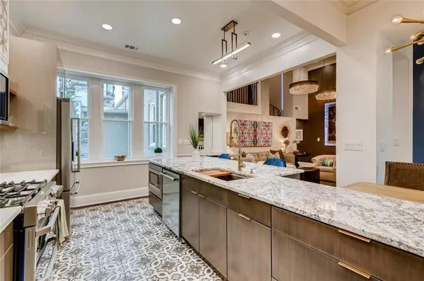 a large kitchen with kitchen island a large counter top space appliances and a counter space