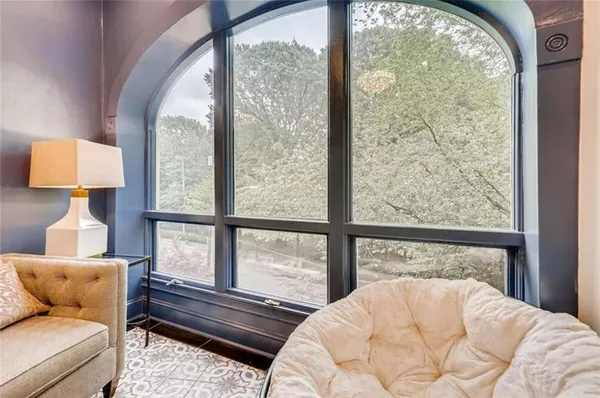 a bedroom with a bed and a large window