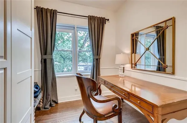 a view of a living room and dining room with furniture window and wooden floor