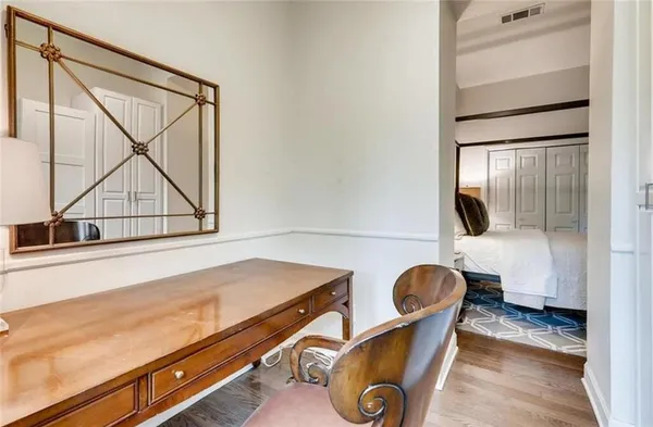 a living room with chair and piano table