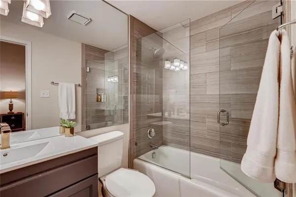 a bathroom with a sink toilet and shower