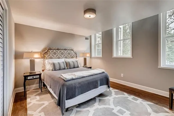 a bedroom with a bed lamps and window