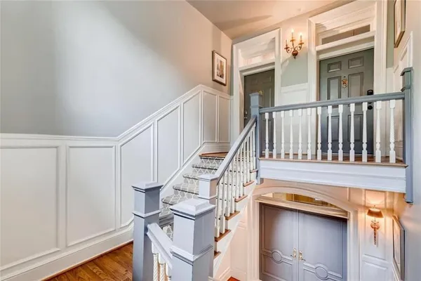 a view of entryway and hall with wooden floor