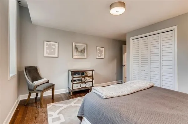 a bedroom with a bed and a chair