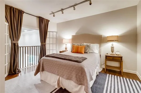 a bedroom with a bed and a night stand