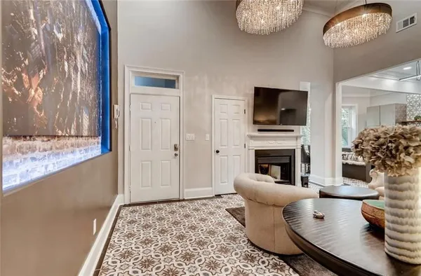 a living room with furniture a fireplace and a flat screen tv