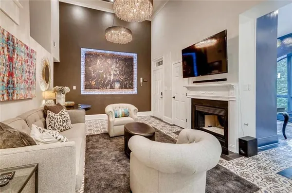 a living room with furniture a flat screen tv and a fireplace