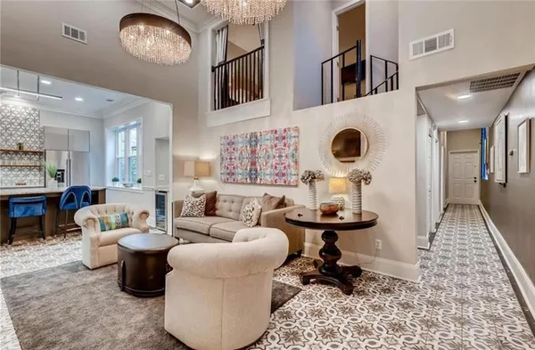 a living room with furniture and a chandelier