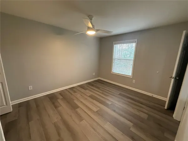 an empty room with wooden floor and closet