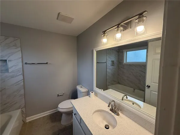 a bathroom with a bathtub and shower