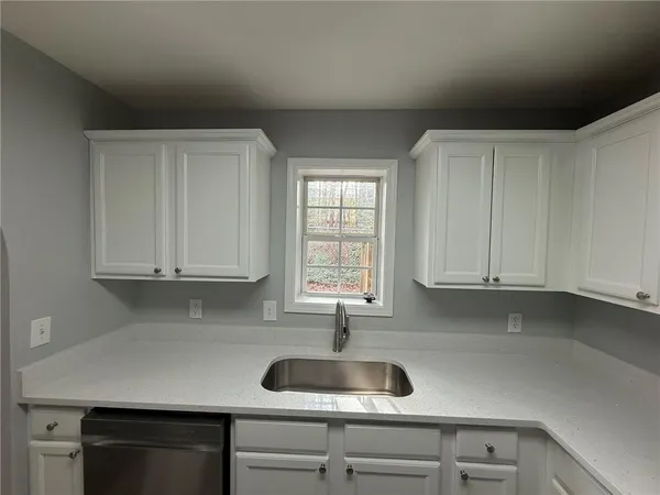 a kitchen with a sink and cabinets