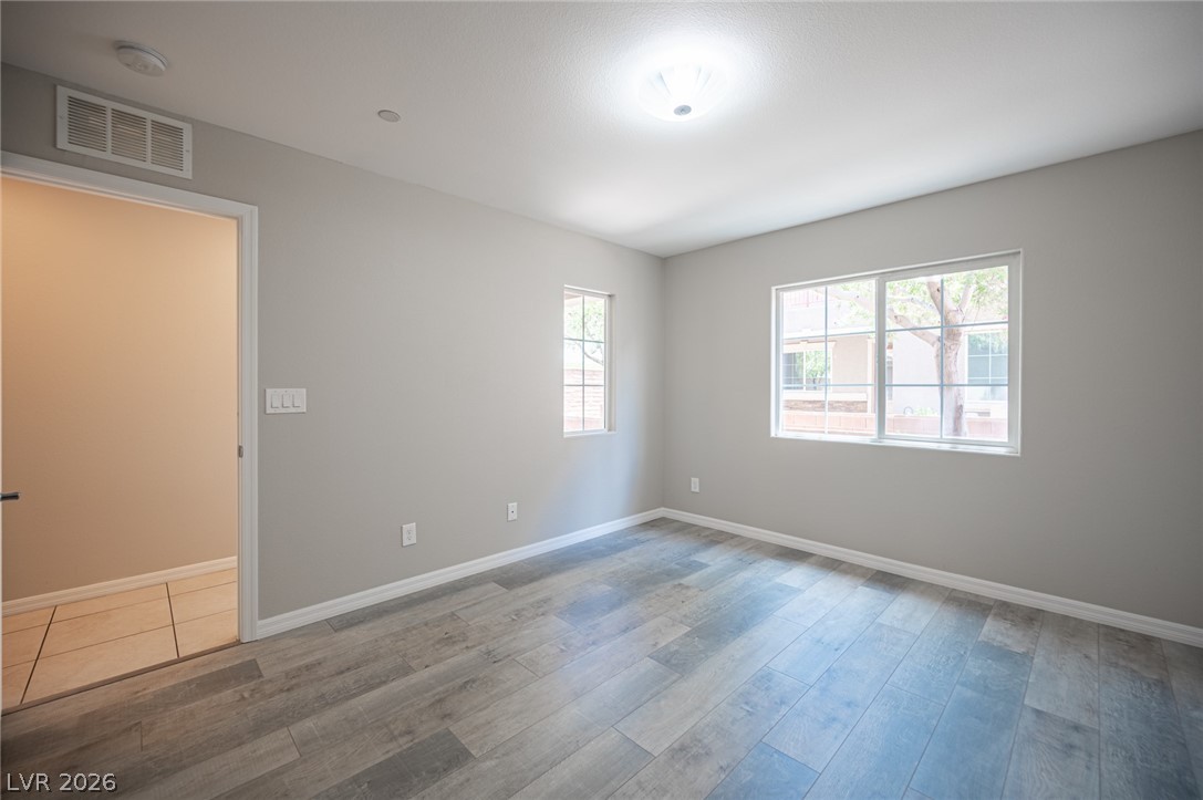 9916 Sable Point Street Las Vegas, NV 89178 - Photo 22 of 73 Natural light floods this room, highlighting the clean, modern flooring.