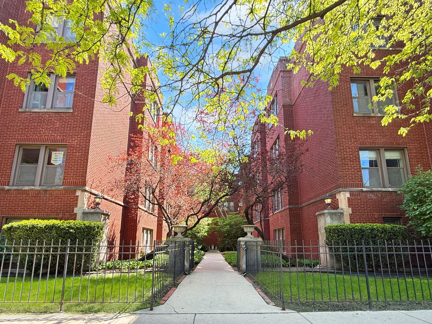 1325 West Addison Street, Unit 1A Chicago, IL 60613 - Photo 1 of 15 a front view of a house with a garden and plants