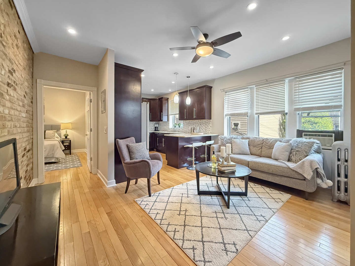 1325 West Addison Street, Unit 1A Chicago, IL 60613 - Photo 3 of 15 a living room with furniture and kitchen view