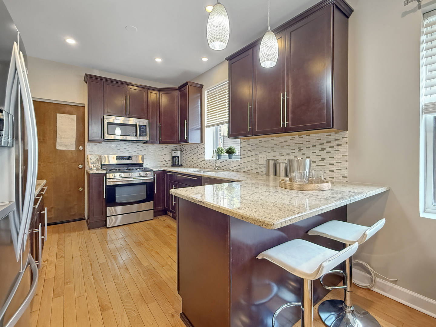 1325 West Addison Street, Unit 1A Chicago, IL 60613 - Photo 4 of 15 a kitchen with a sink appliances and cabinets