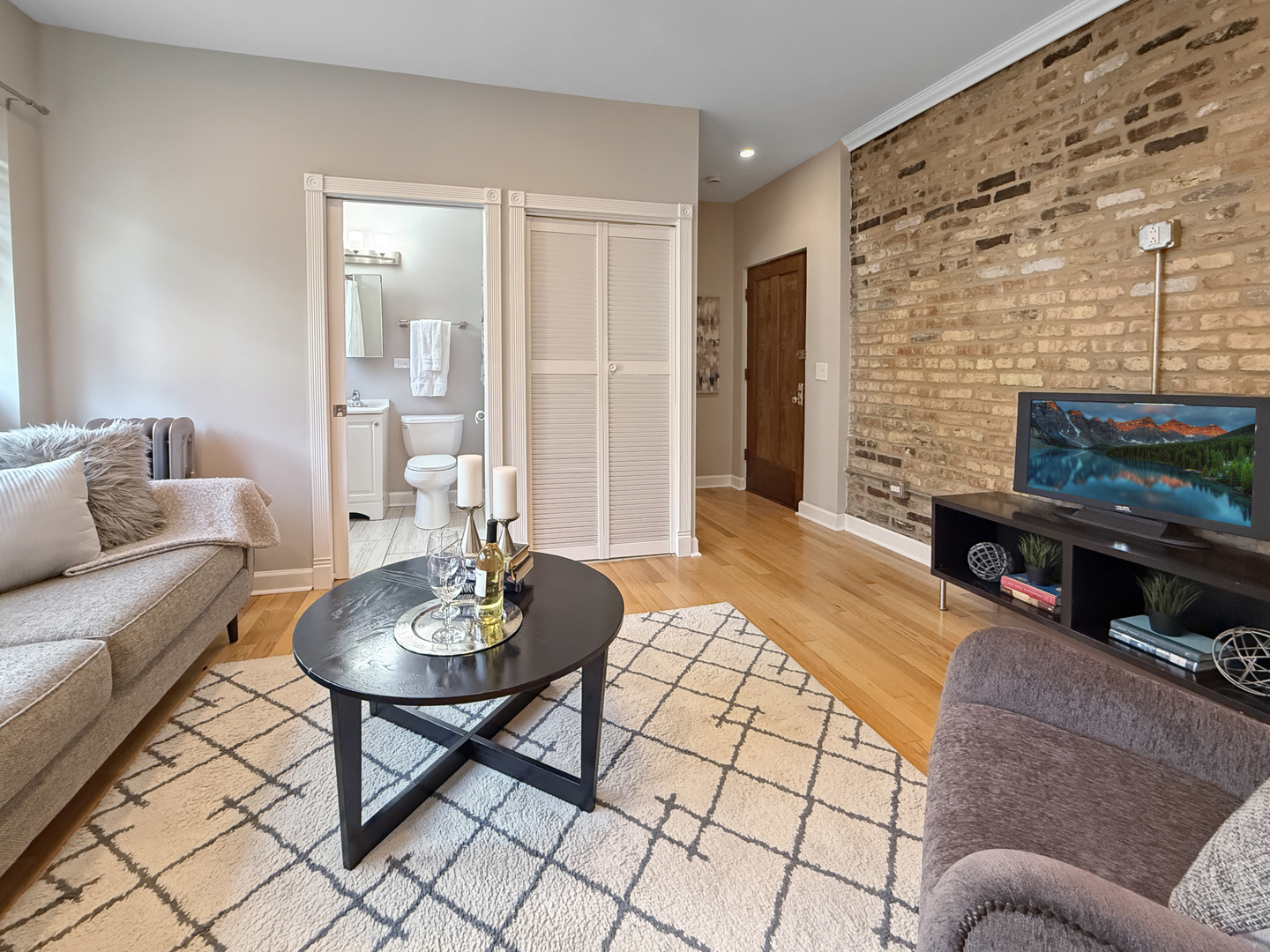 1325 West Addison Street, Unit 1A Chicago, IL 60613 - Photo 6 of 15 a living room with furniture and a fireplace