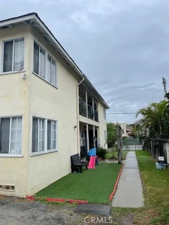 a front view of a house with a yard and trees
