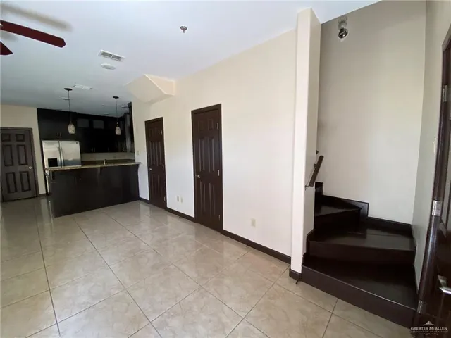 a view of kitchen with refrigerator and window