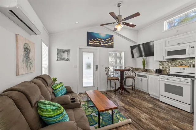 a living room with furniture and kitchen view