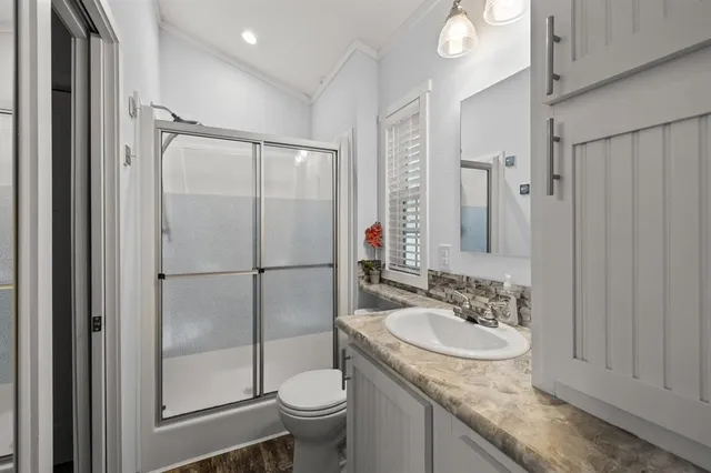 a bathroom with a sink toilet and shower