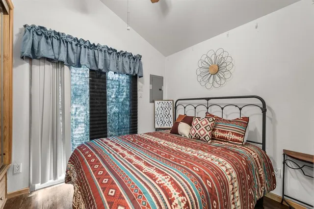 a bedroom with a large bed and a window