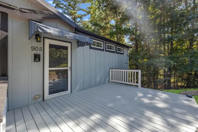 a view of backyard with deck and wooden floor
