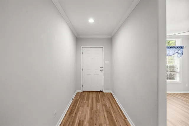 a view of a room with wooden floor and bench