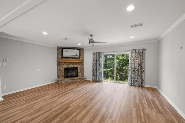 wooden floor fireplace and natural light in room