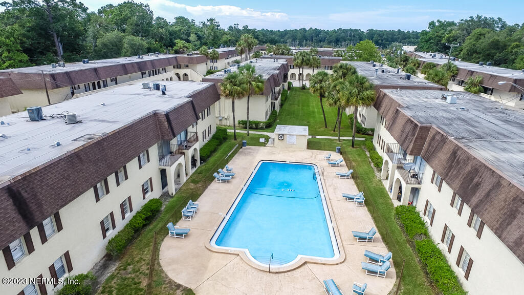 1735 El Camino Road, Unit 5 Jacksonville, FL 32216 - Photo 20 of 32 a view of a swimming pool with a yard and seating area