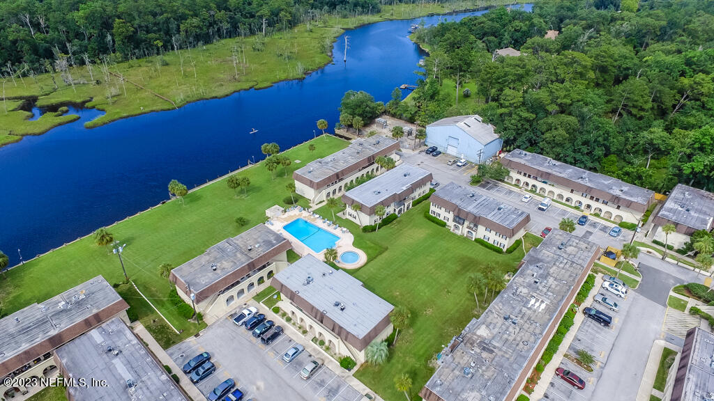 1735 El Camino Road, Unit 5 Jacksonville, FL 32216 - Photo 24 of 32 an aerial view of a house with a garden and lake view