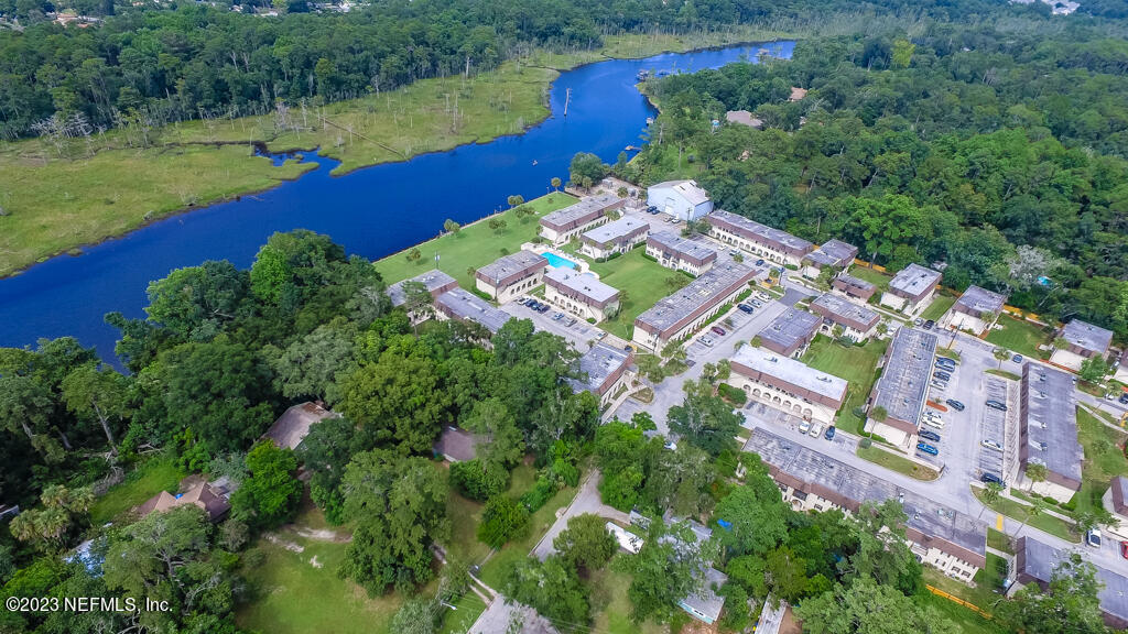 1735 El Camino Road, Unit 5 Jacksonville, FL 32216 - Photo 25 of 32 an aerial view of a house with a garden and lake view