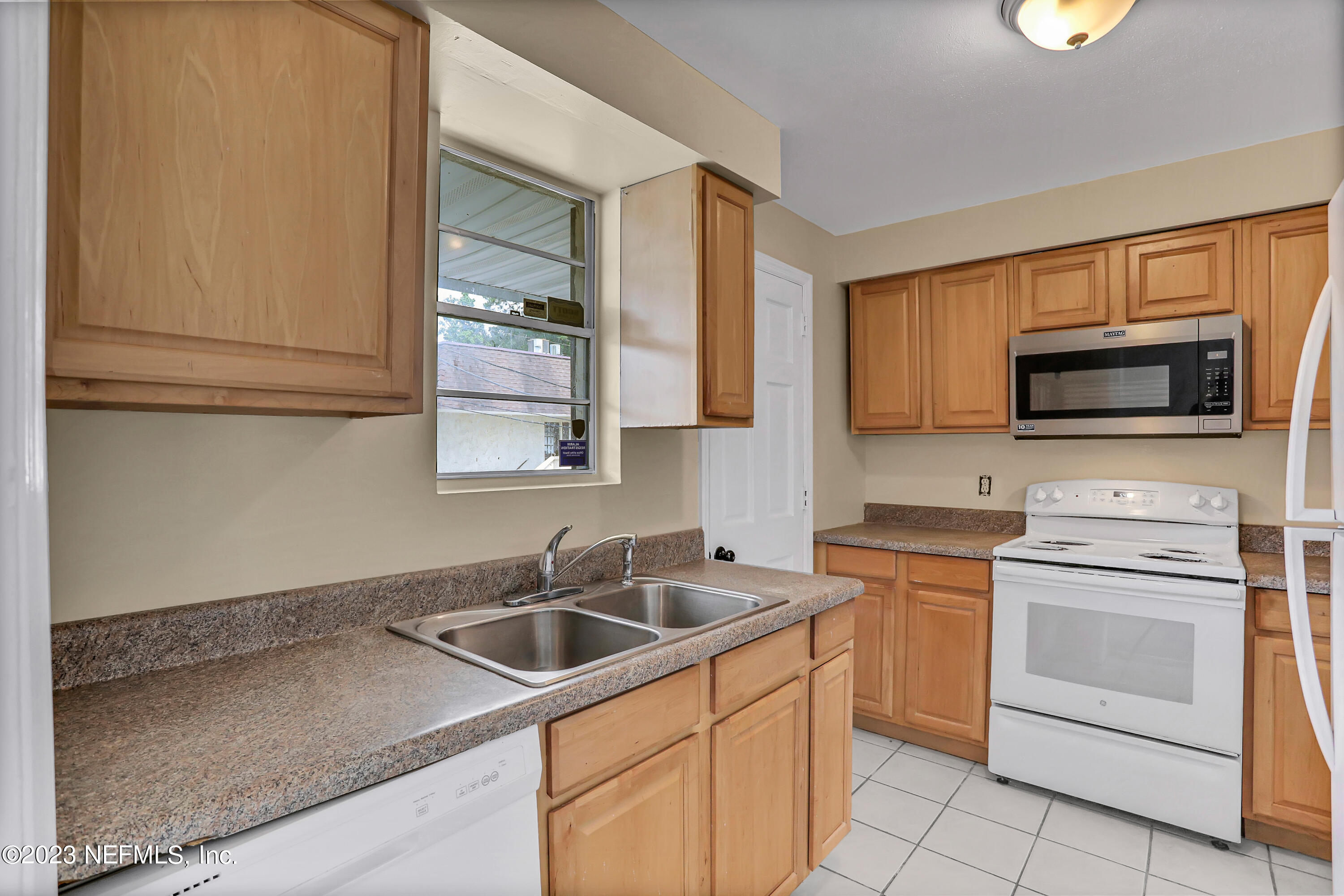 1735 El Camino Road, Unit 5 Jacksonville, FL 32216 - Photo 26 of 32 a kitchen with stainless steel appliances granite countertop a sink stove and microwave