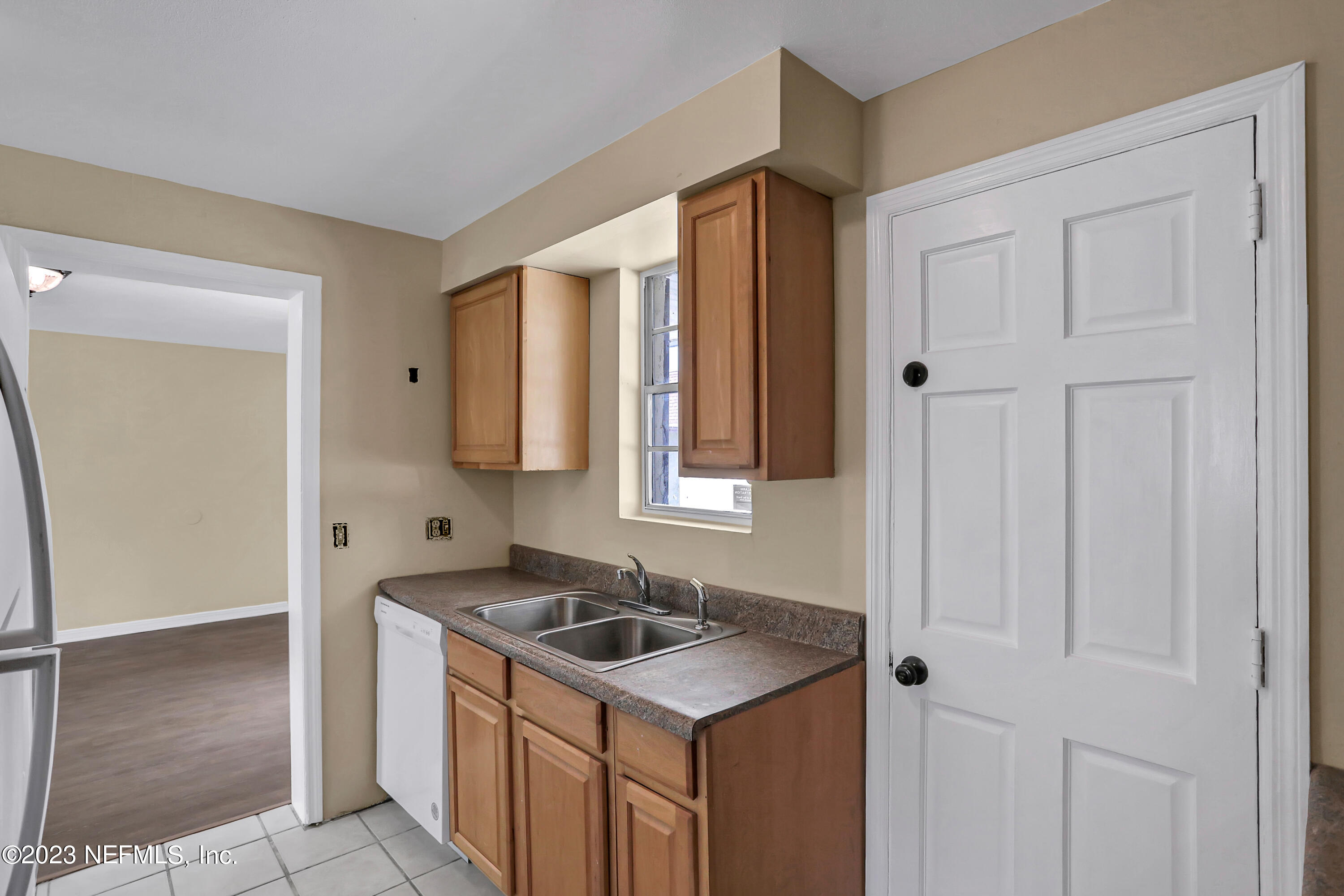 1735 El Camino Road, Unit 5 Jacksonville, FL 32216 - Photo 27 of 32 a kitchen with stainless steel appliances granite countertop a sink and a refrigerator